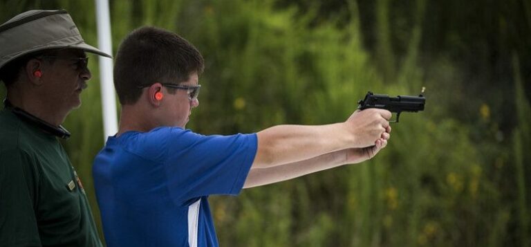Youth shooting pistol